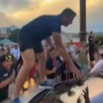 A French MP climbs on a hood to celebrate PSG’s title